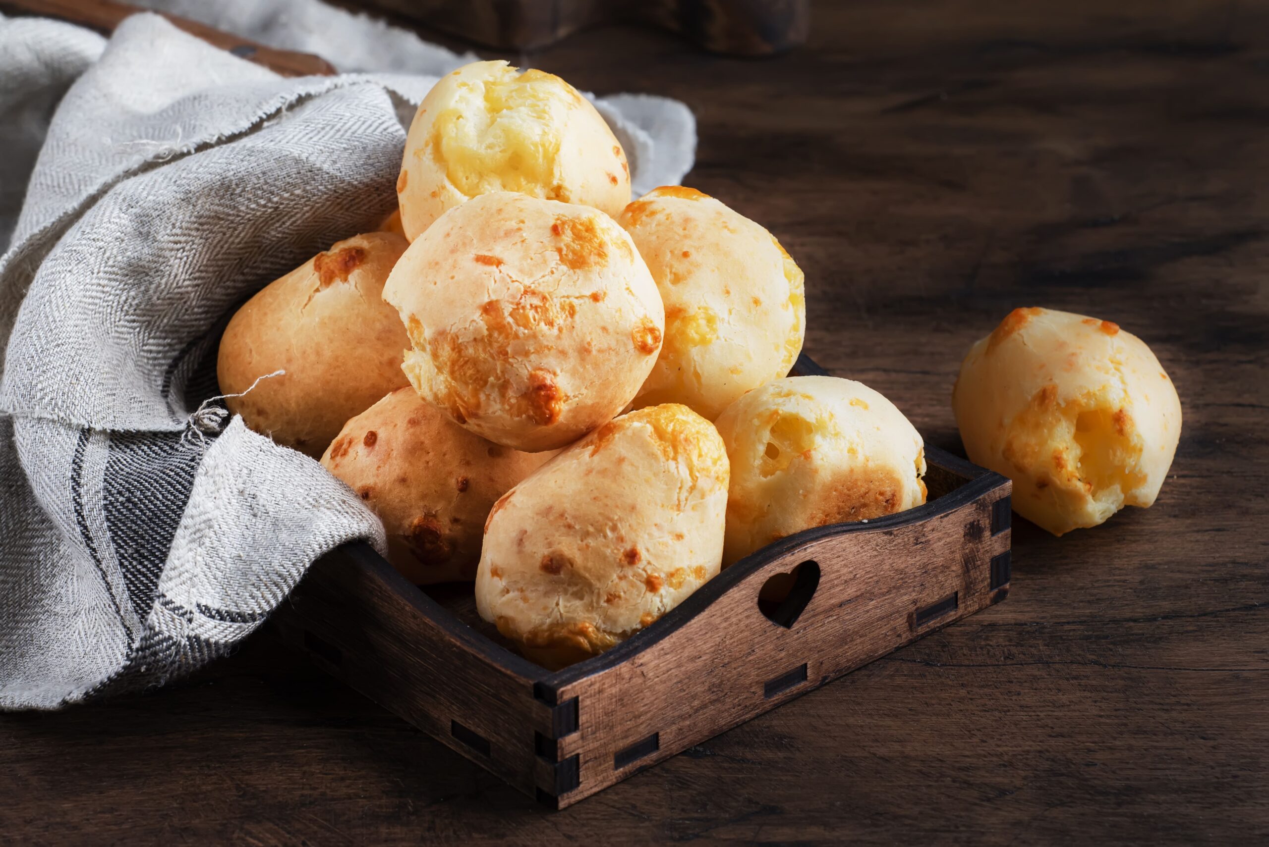 golden-cheese-buns-in-wooden-tray-2023-11-27-05-10-01-utc-min